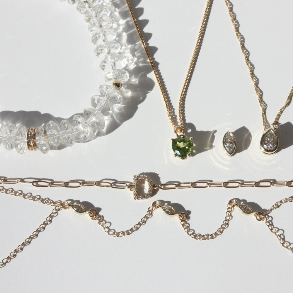 Joyful and Co fine 14k gold pave diamond initial necklaces and diamond hand chain bracelets.