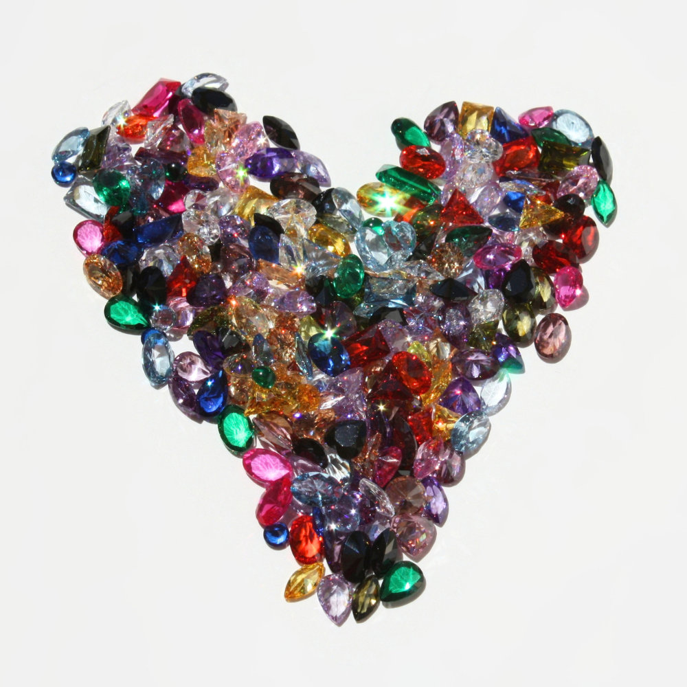 "Handcrafted rainbow gemstone jewelry collection featuring multi-color solid gold and sterling silver rings, bangles, and necklaces."