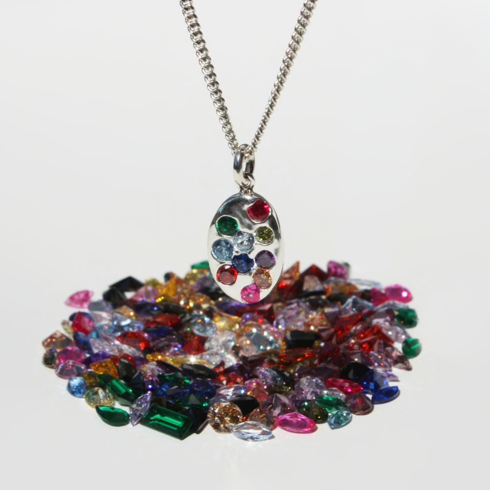 "Joyful and Co .999 fine silver oval coin rainbow gemstone pendant on a sterling silver curb chain."