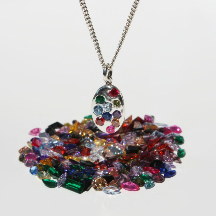 "Joyful and Co .999 fine silver oval coin rainbow gemstone pendant on a sterling silver curb chain."