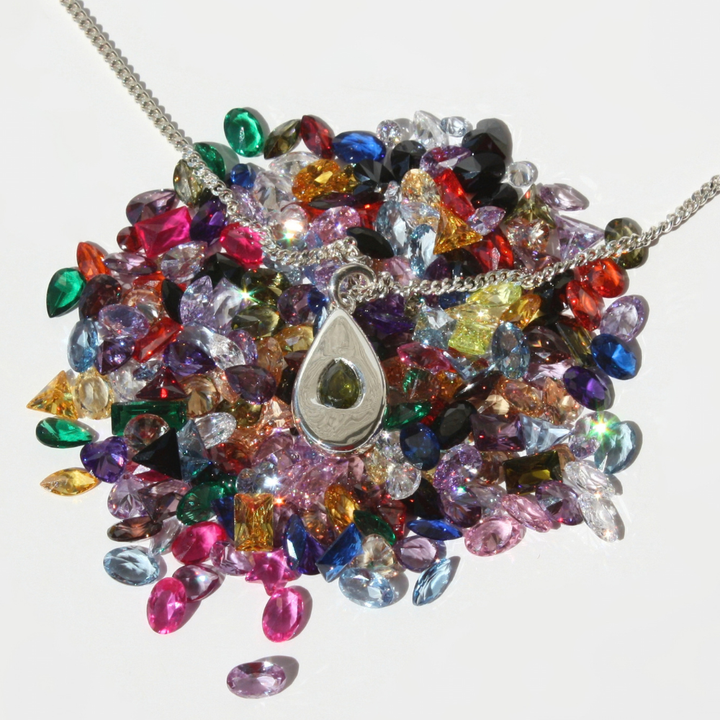 "Collection of fine silver sand cast pear pendant pear gemstone necklaces shown in multiple stone colors."