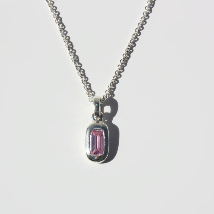 Joyful and Co .999 fine silver baguette pendant necklace with lab grown pink stone on a curb chain.
