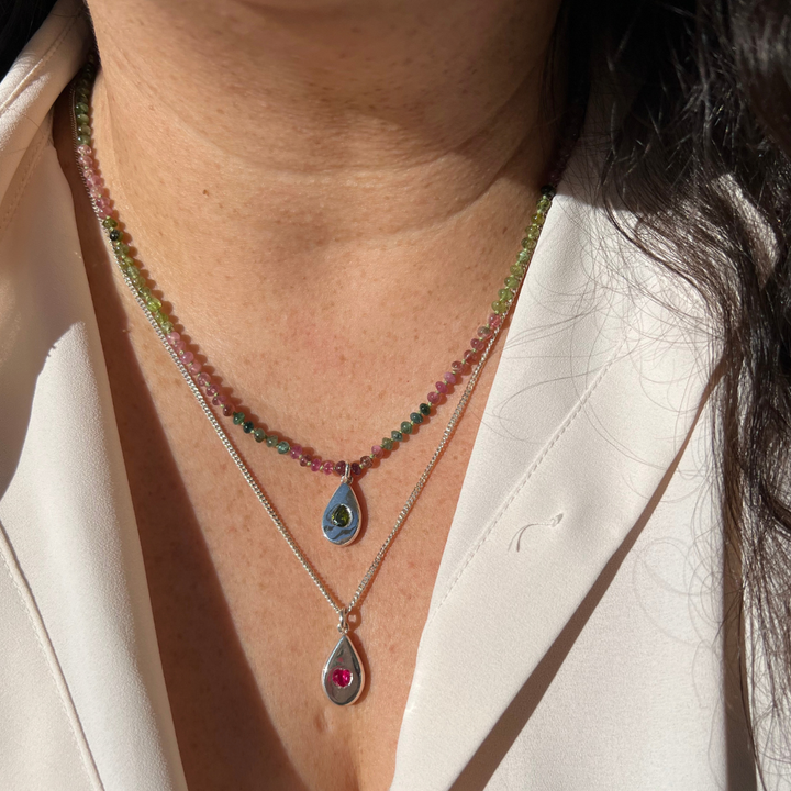 Model Wearing Two Teardrop Pendant necklaces on a Silver Curb chain and on a tourmaline Beaded Necklace.