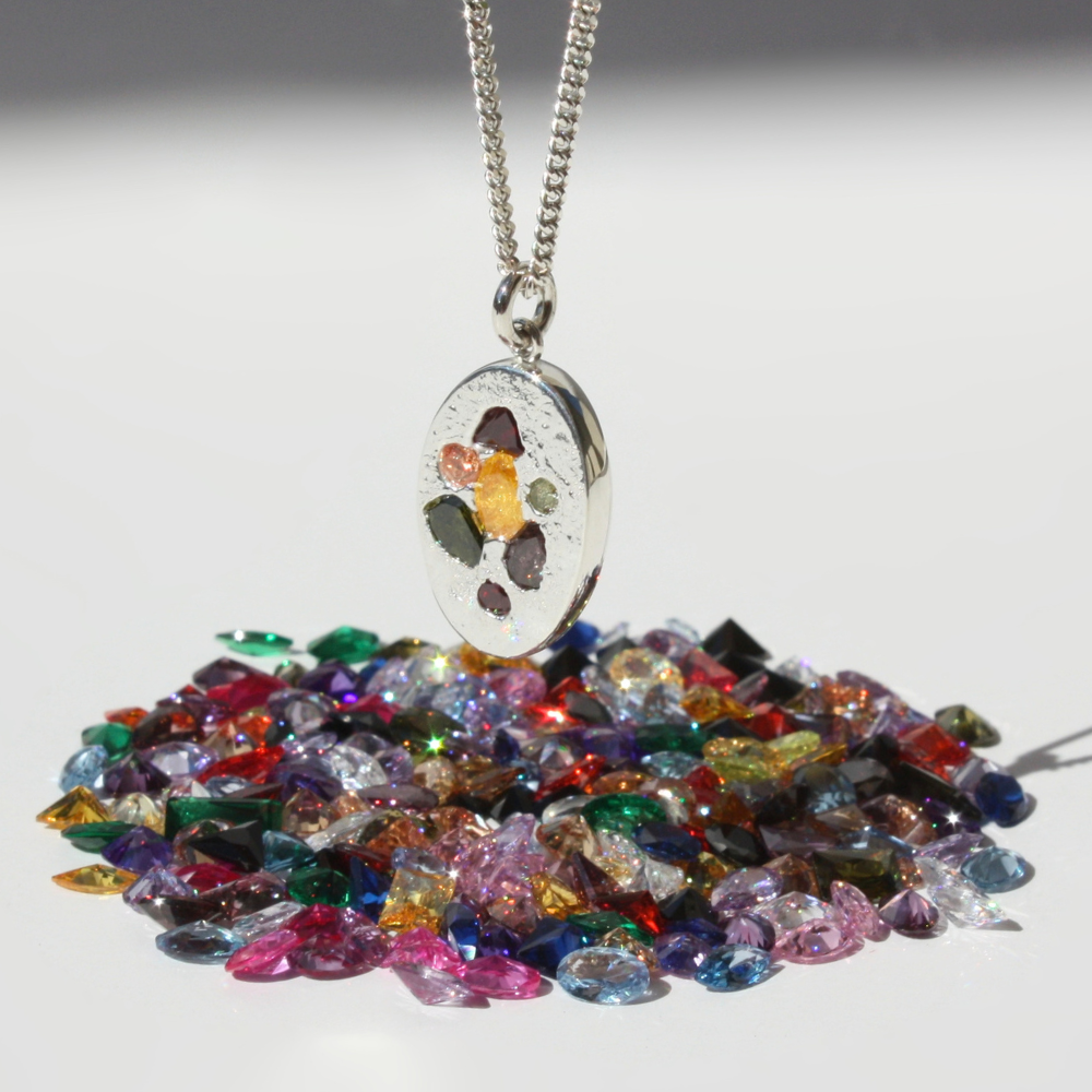 "Joyful and Co .999 fine silver sand cast oval coin multi gemstone pendant on a sterling silver curb chain."