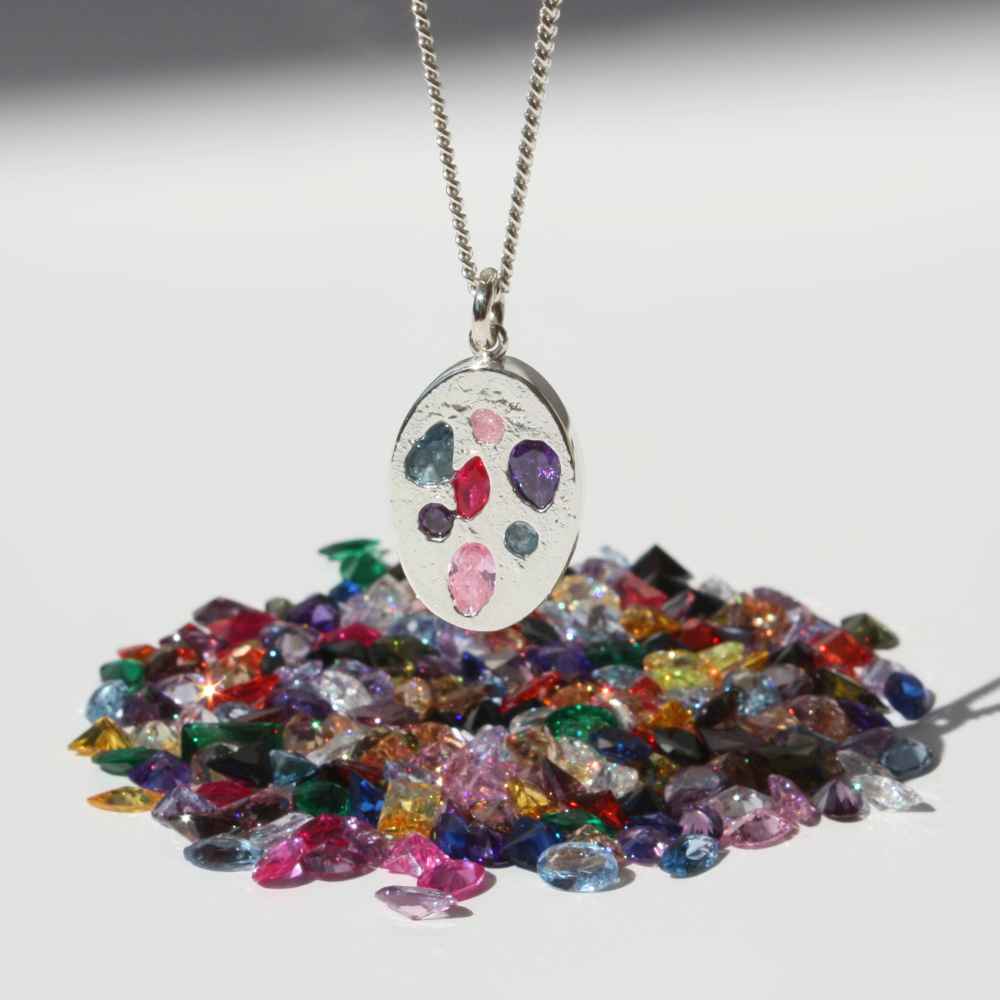 "Joyful and Co .999 fine silver sand cast oval coin soft pastel gemstone pendant on a sterling silver curb chain."