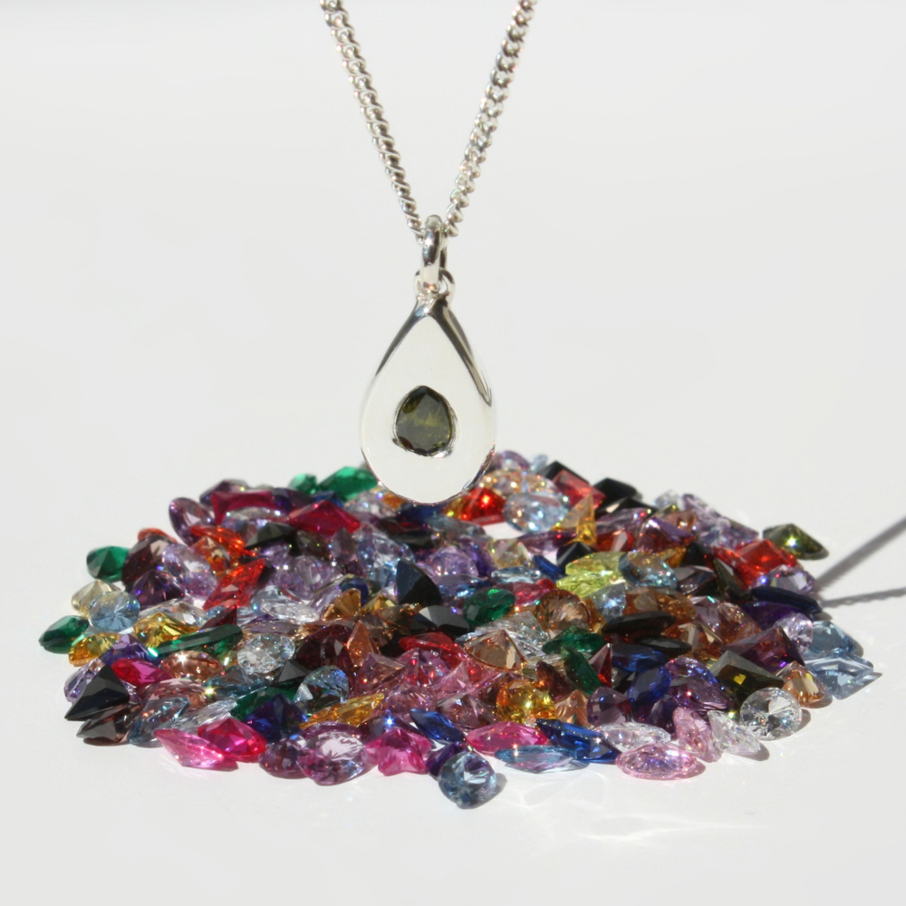 "Joyful and Co .999 fine silver sand cast pear pendant with pear gemstone on a sterling silver curb chain."