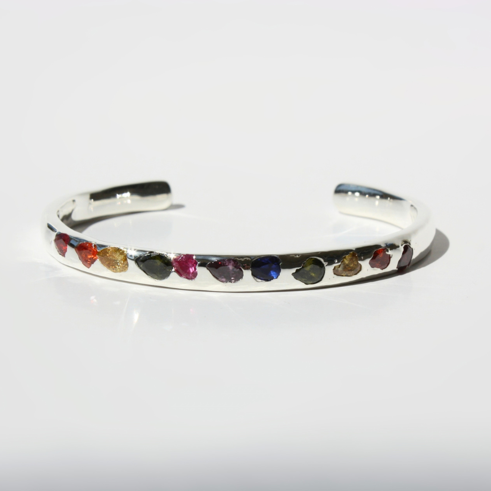 "Joyful and Co .925 sterling silver sand cast cuff bracelet with all around rainbow gemstones."