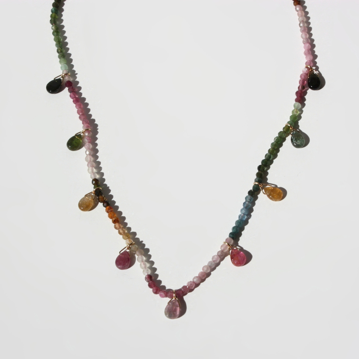 "Joyful and Co watermelon tourmaline beaded necklace hand-knotted in silk with scattered teardrops and gold clasp."