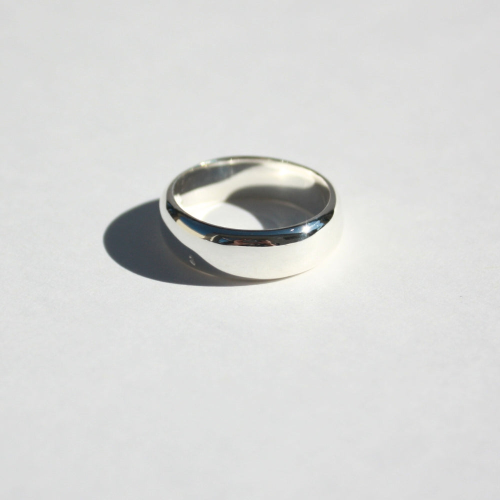 "Joyful and Co .925 sterling silver wide sand cast organic ring band."