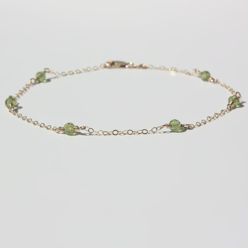 A selection of genuine gemstone options including sunstone, goldstone, and birthstones for the custom Joyful and Co anklet.